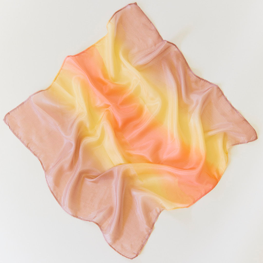 Gradient scarf transitioning from beige to yellow on a light background