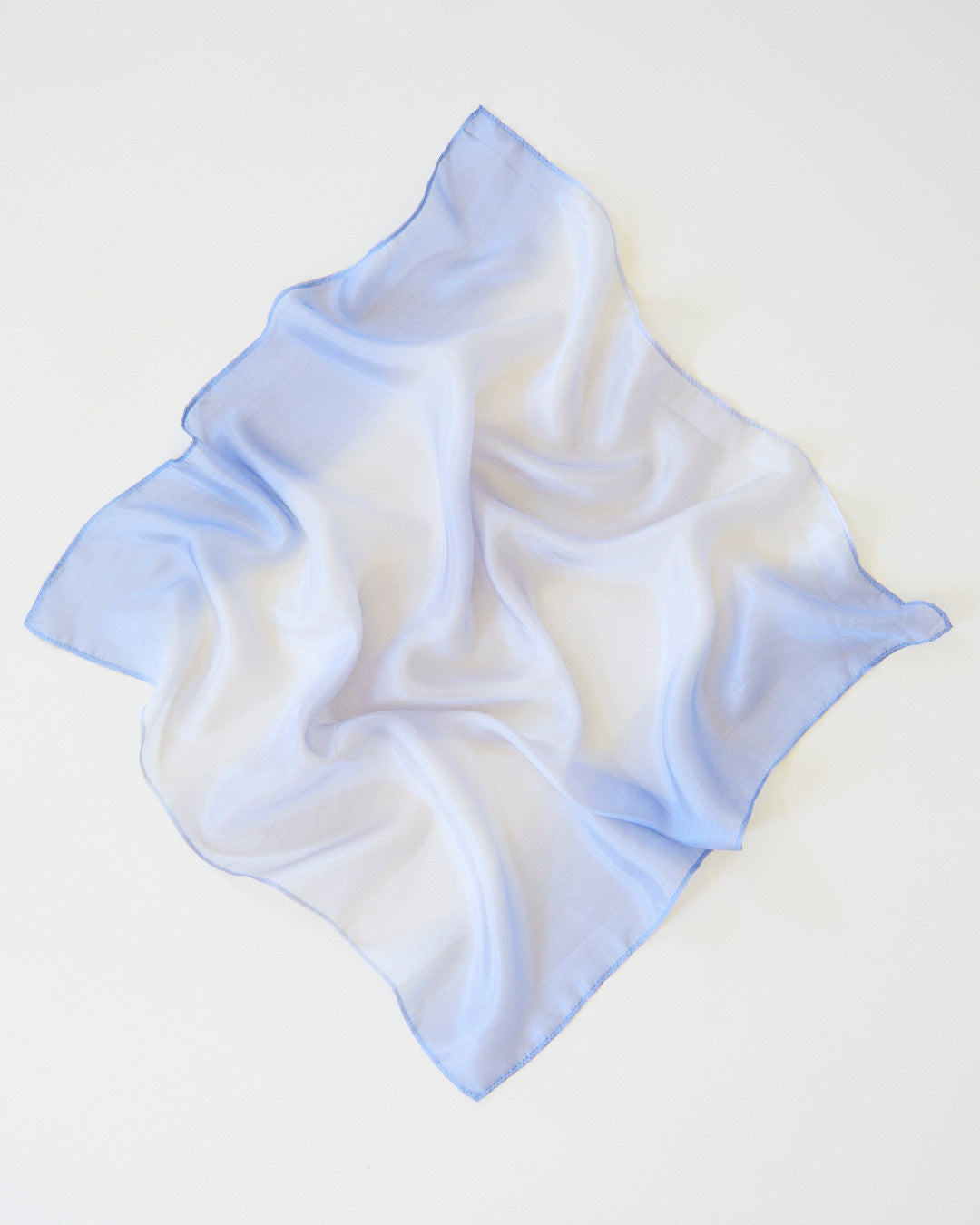 Light stone coloured silk on a white background
